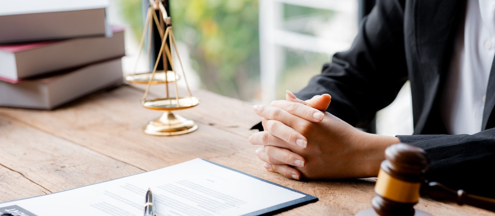 A woman lawyer sits in the office of her law firm.