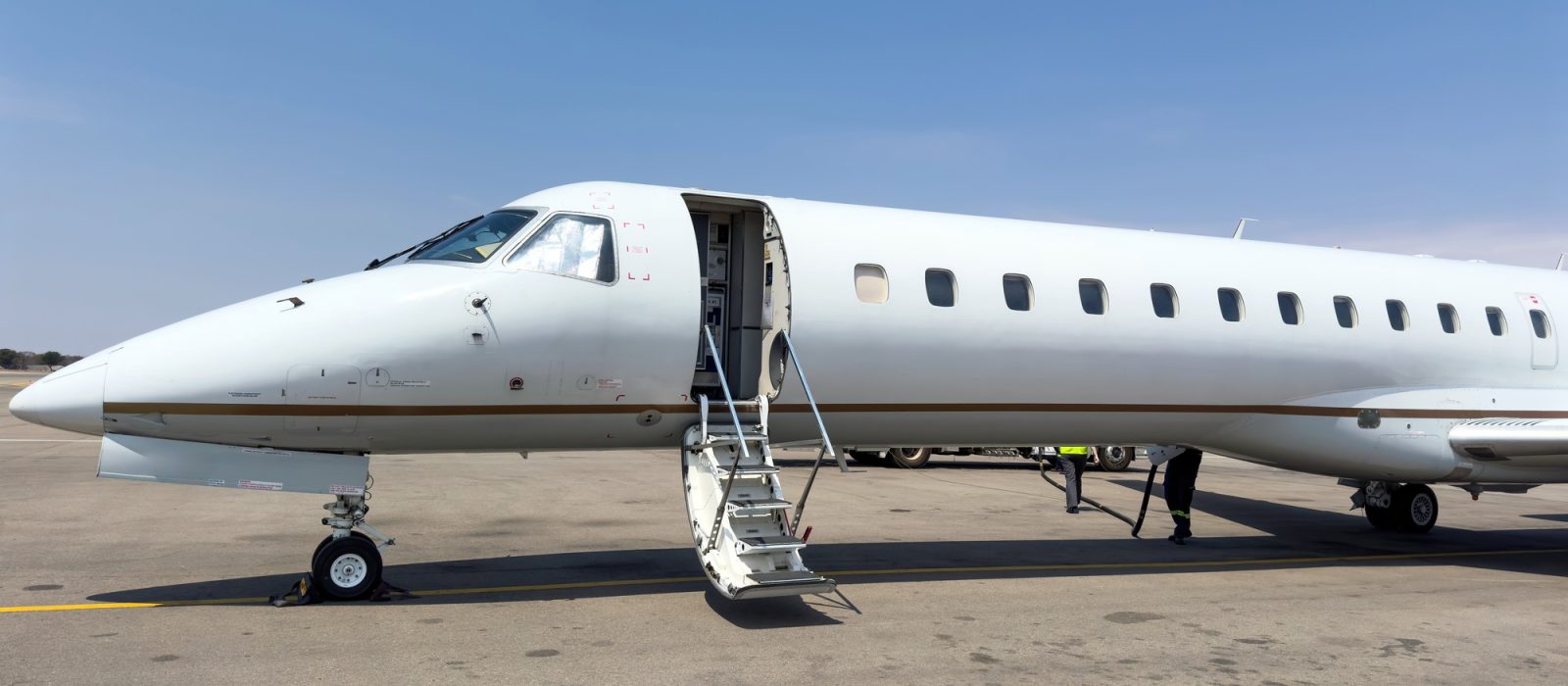 Learjet, Private Jet plane landed at Airpor runway. Blue sky background