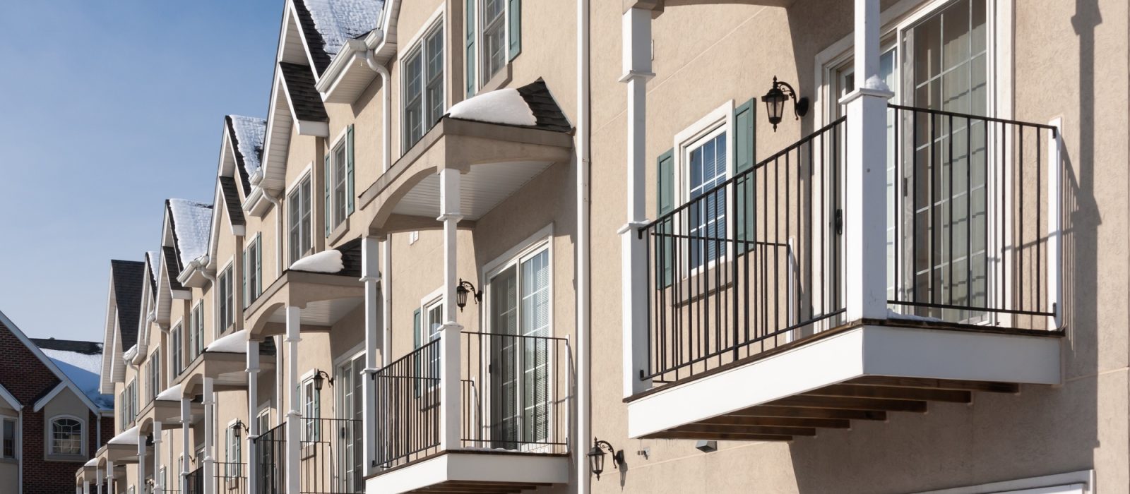 Row of Apartment Condominiums Balconies and Garage Doors.